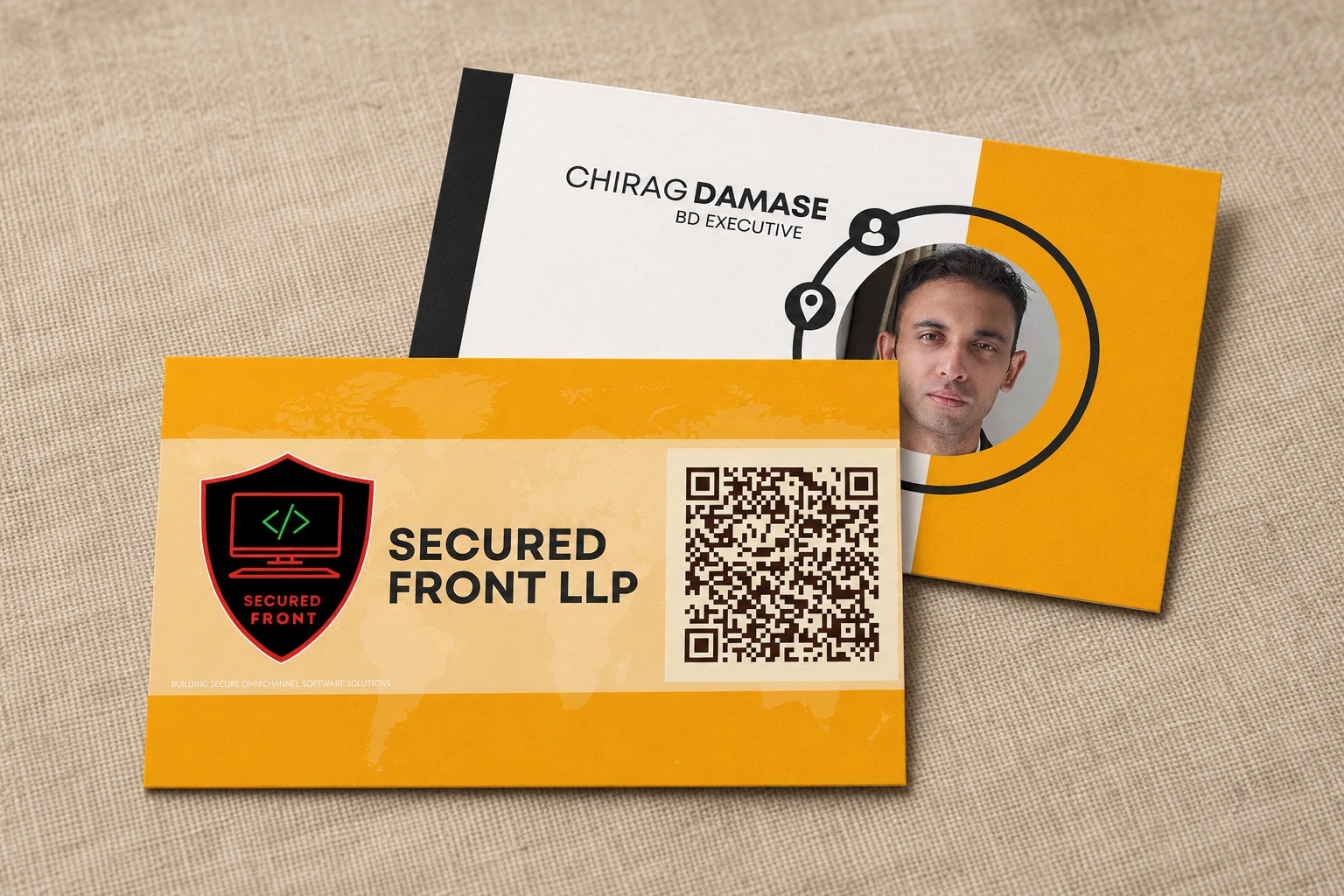 Front and back of a yellow Secured Front business card, including a large printed QR code, on a neutral fabric background